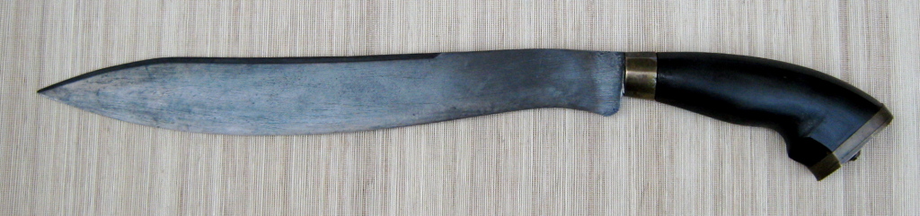 The bolo is a heavy 19th century blade believed to have originated from the Batangas province in Luzon, Philippines. This substantial knife has a large handle made of horn with brass fittings. The blade is heavy and well-made with a false edge on the backside of the blade. Overall length: 511 mm (20.1 inches); Blade length: 352 mm (13.9 inches); Maximum blade thickness: 7 mm (1/4 inch) Photo Credit: Lorenz Lasco http://filhistory.com
